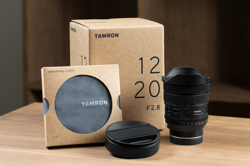 High-quality Tamron 12-20mm f/2.8 lens with protective case and packaging.