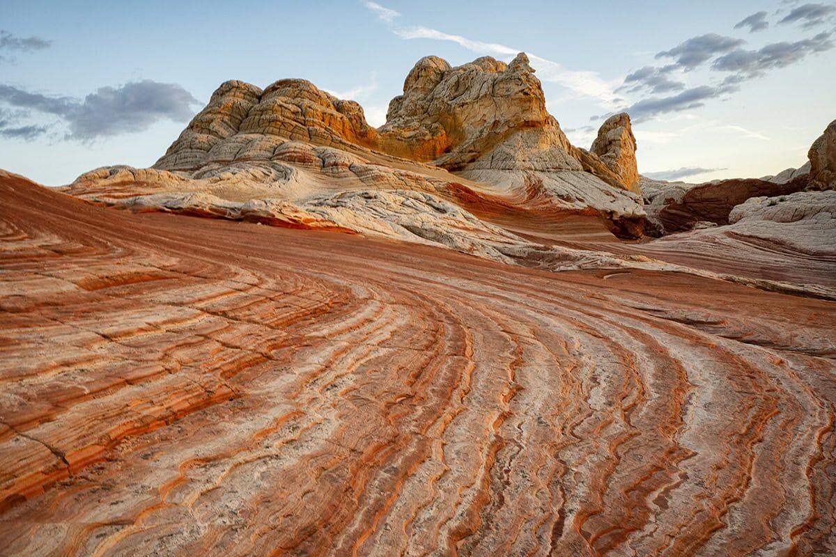 Scenic desert with layered rock formations taken with a Tamron lens.