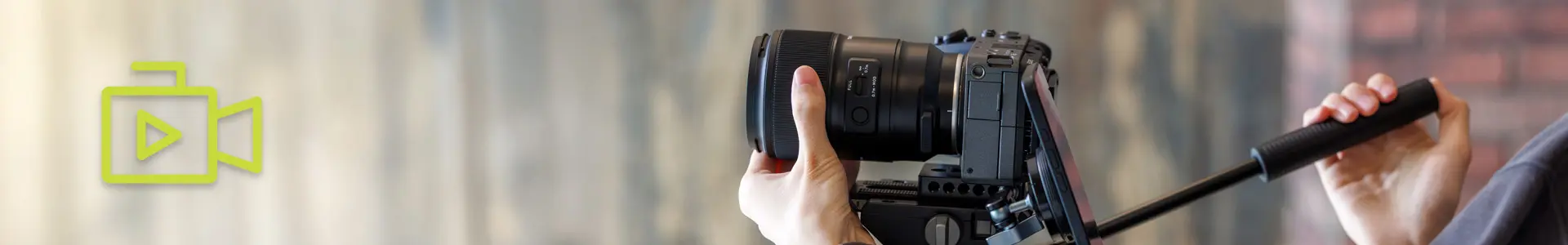 Tamron Lens in Use for Photography Photographer holding a Tamron lens camera for professional photography.